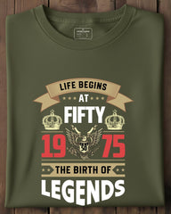 Green t-shirt with birthday design on a wooden surface