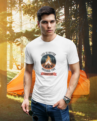 Man wearing a white t-shirt with a campfire design in a forest setting