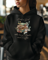 Person wearing a black hoodie with a design and text, blurred background