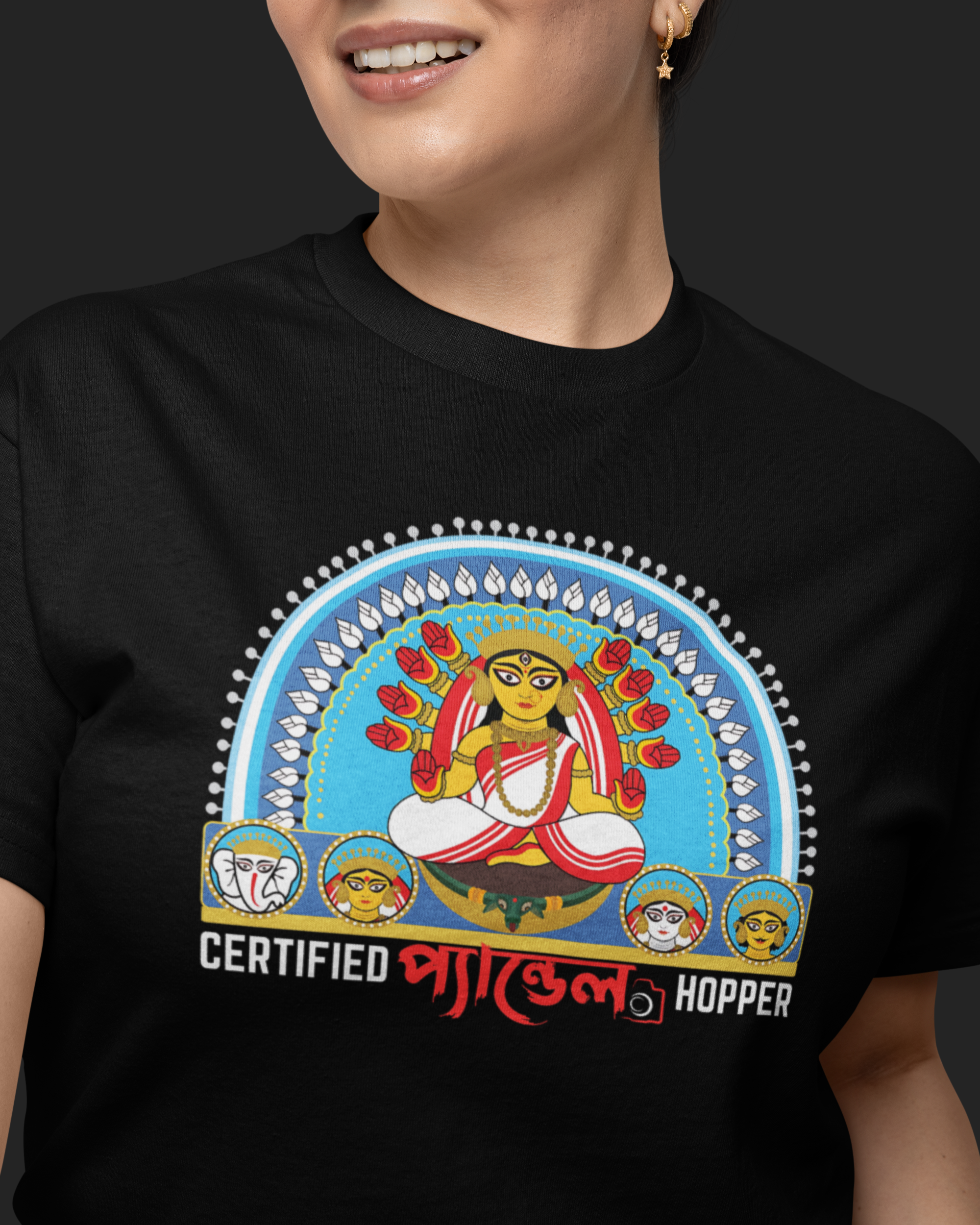 Person wearing a black t-shirt with a colorful graphic and text on a dark background