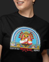 Person wearing a black t-shirt with a colorful graphic and text on a dark background