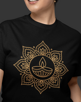 Person wearing a black t-shirt with a gold mandala design on a dark background
