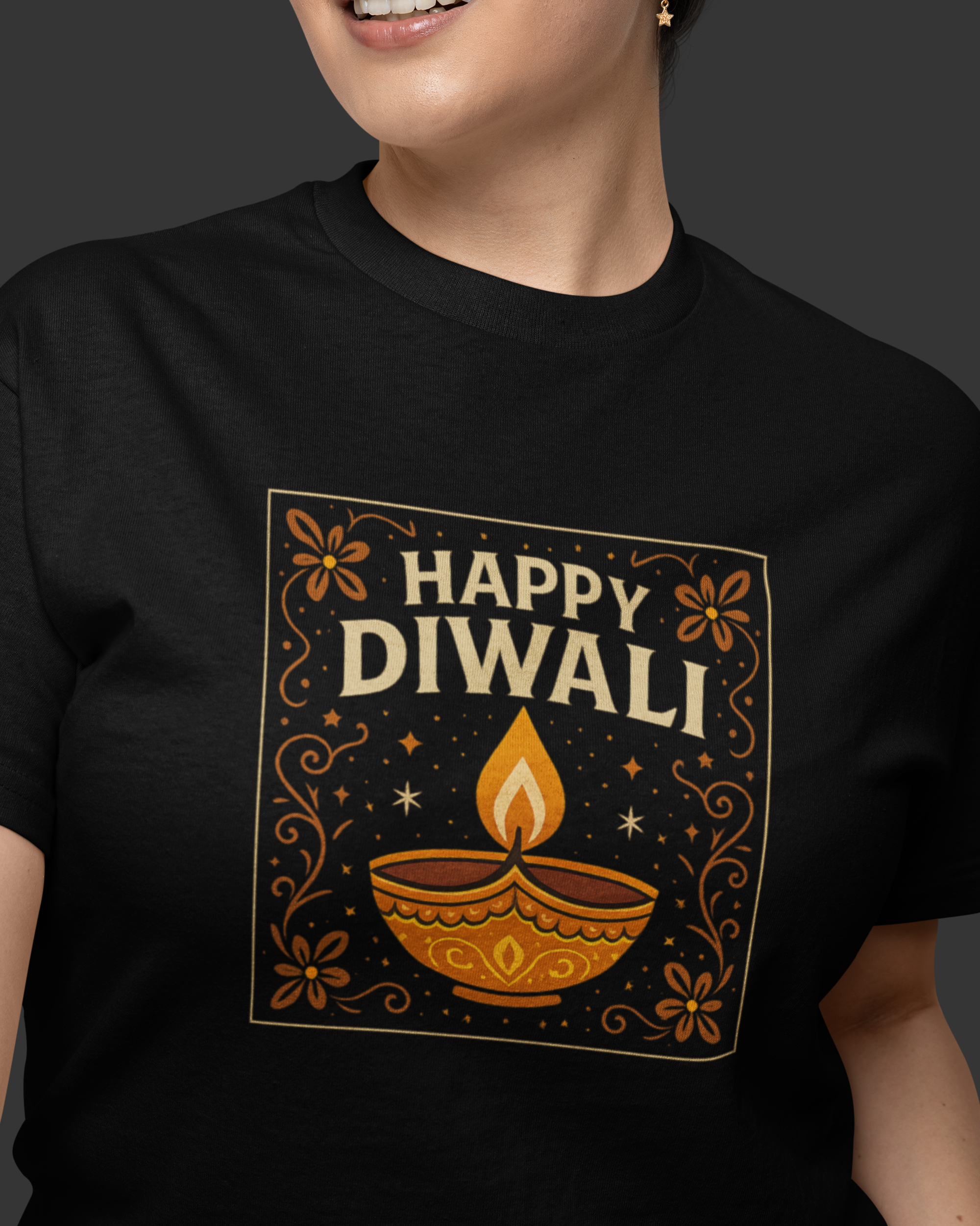 Person wearing a black t-shirt with 'Happy Diwali' design featuring a lamp and flowers.