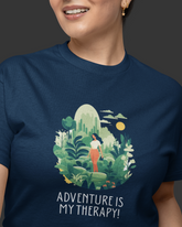 Person wearing a navy blue t-shirt with a nature-themed graphic and 'Adventure is My Therapy!' text.