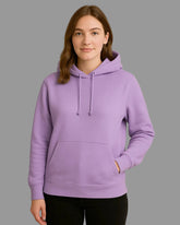 Person wearing a purple hoodie against a beige background