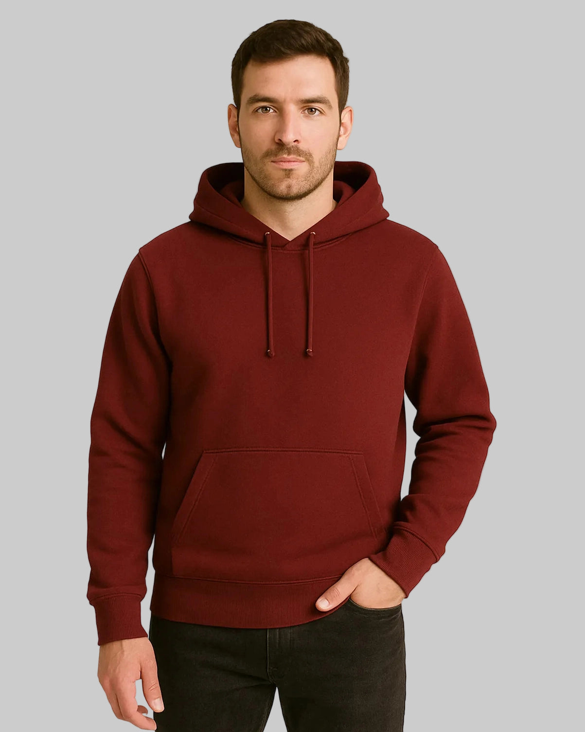 Man wearing a maroon hoodie against a beige background