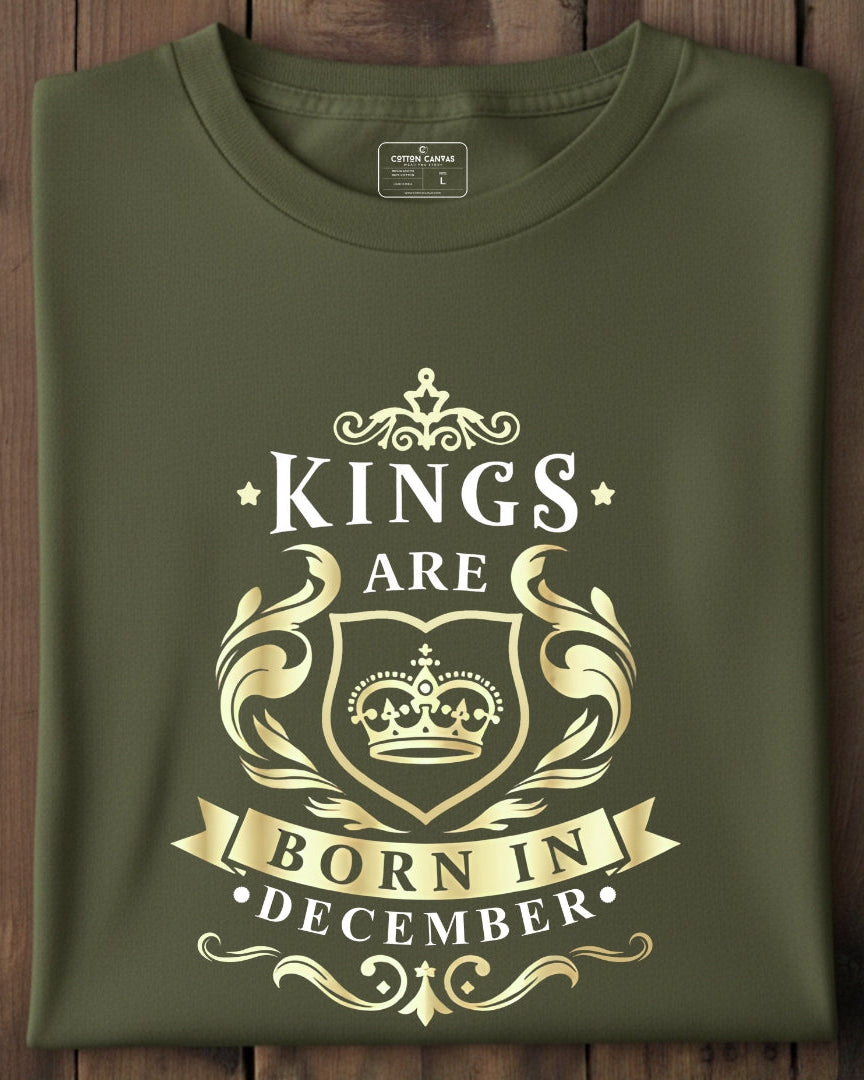 Green t-shirt with gold text and design on a wooden surface