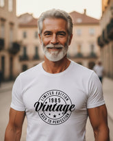 Man wearing a white t-shirt with 'Vintage' design in an urban setting