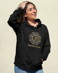 Person wearing a black hoodie with a symbol and text on a beige background