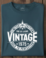 Folded blue t-shirt with vintage design on a wooden surface