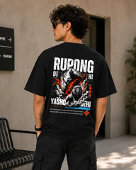 A man wearing a black graphic t-shirt with 'RUPONG DEHA' and a lion print on the back, photographed in an outdoor setting.