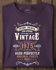 Folded purple t-shirt with vintage text design on a wooden surface