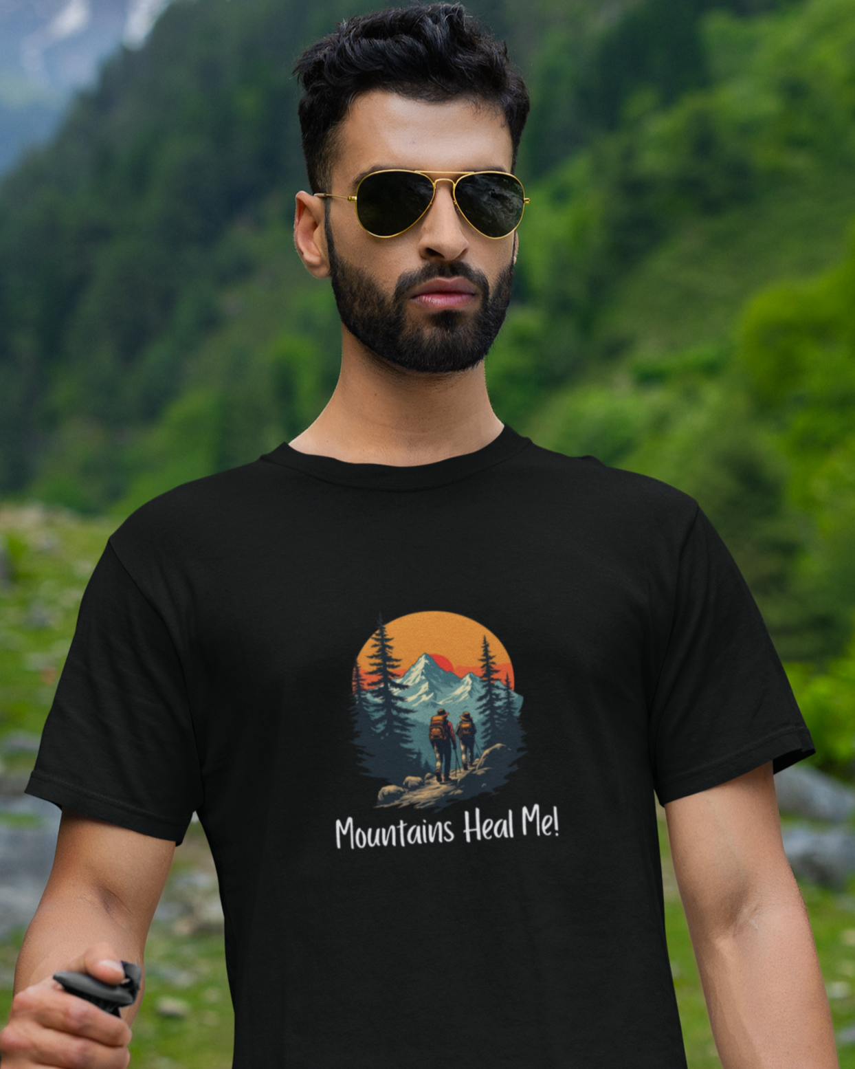 Man wearing a black t-shirt with 'Mountains Heal Me' design in a mountainous landscape