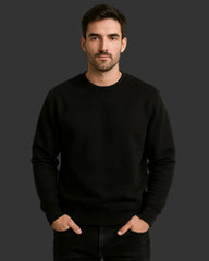 Man wearing a black sweatshirt against a dark background