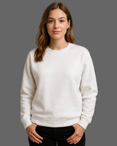 Woman wearing a white sweatshirt against a plain background