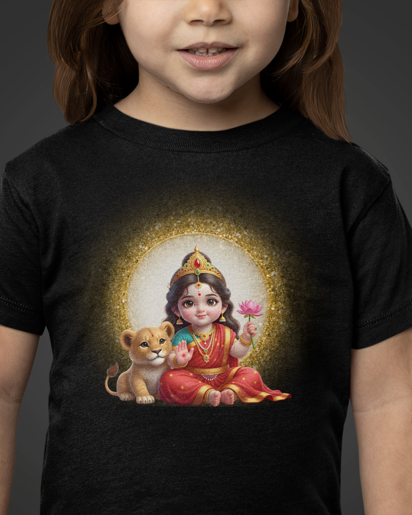 Child wearing a black t-shirt with a colorful graphic of a seated figure holding a flower and a lion cub.