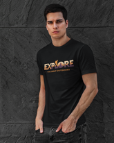 Man wearing a black t-shirt with 'EXPLORE The Great Outdoors' text against a dark stone wall.