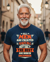 Man wearing a navy blue t-shirt with a humorous message on a city street background