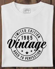 White t-shirt with black text design on a wooden surface