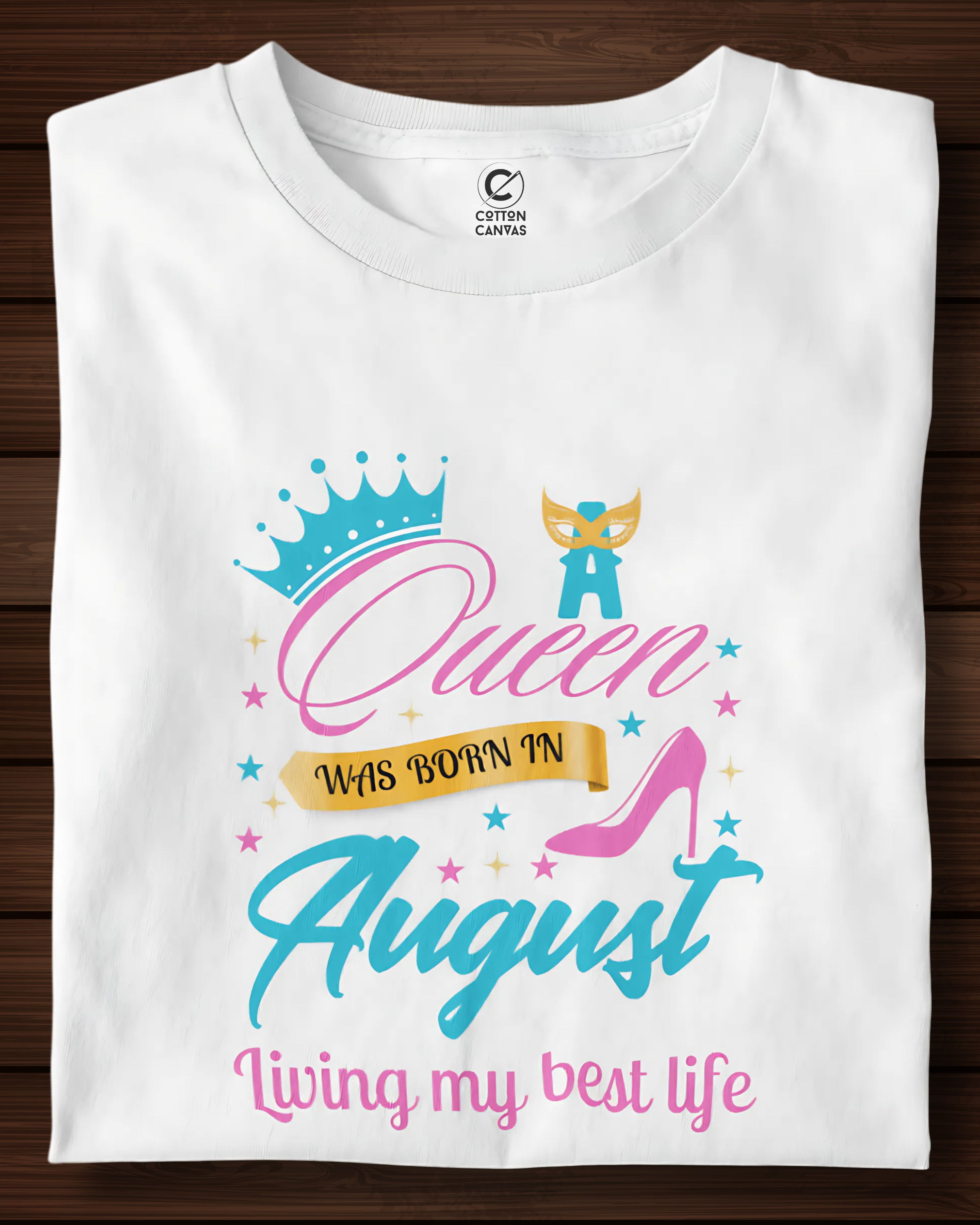 White t-shirt with colorful graphic and text on a wooden surface