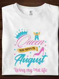 White t-shirt with colorful graphic and text on a wooden surface