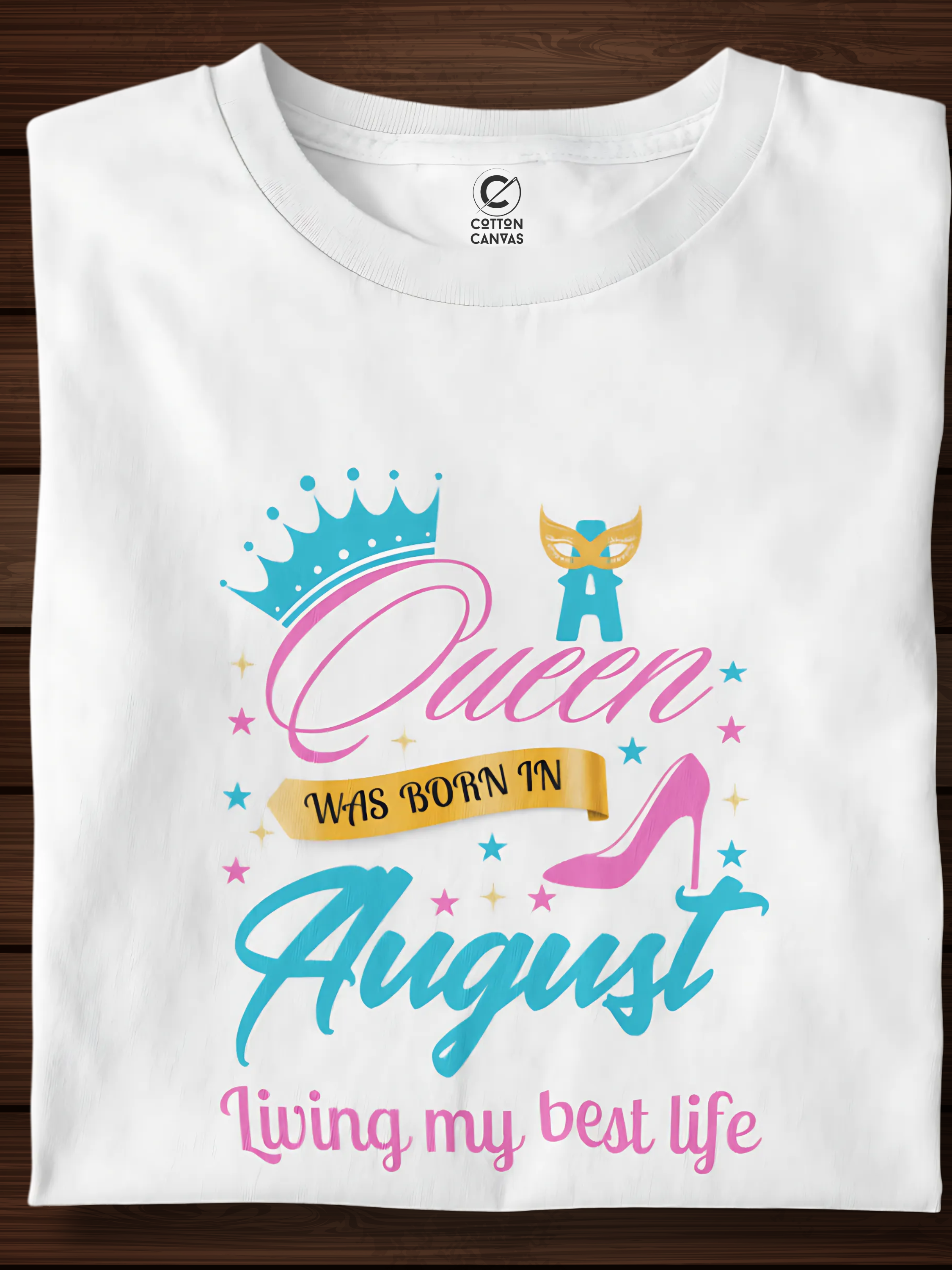 White t-shirt with colorful graphic and text on a wooden surface