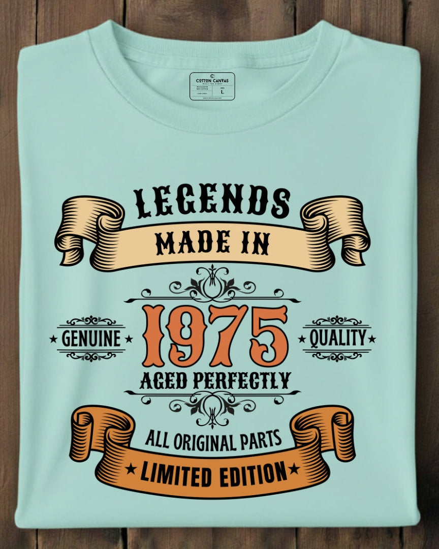 Light blue t-shirt with text 'Legends Made in 1975' on a wooden background