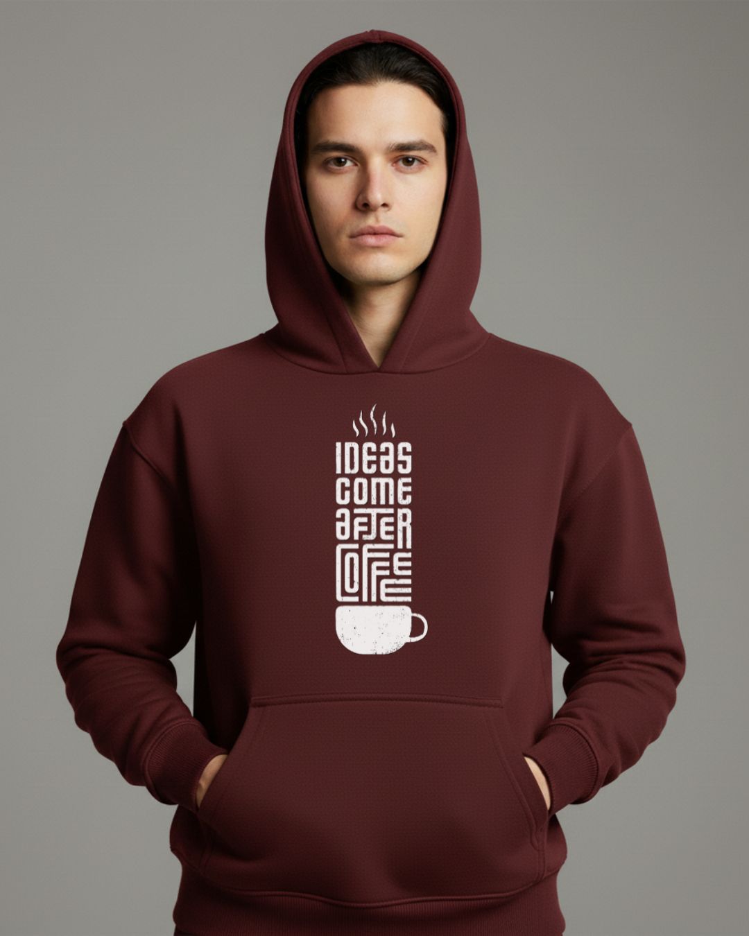 Man wearing a maroon hoodie with a graphic design on a gray background