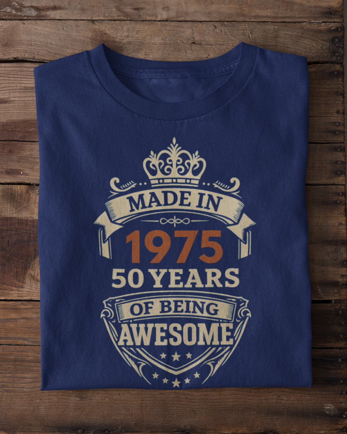 Blue t-shirt with 'Made in 1975, 50 years of being awesome' text on a wooden surface.