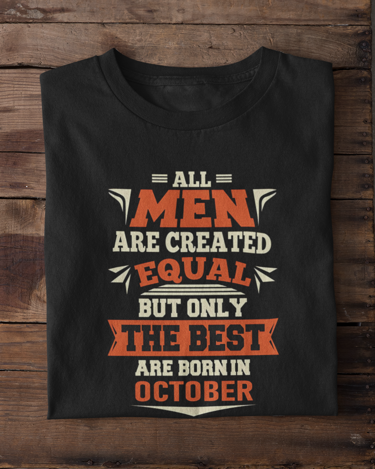 Black t-shirt with a humorous quote on a wooden surface with white sneakers.