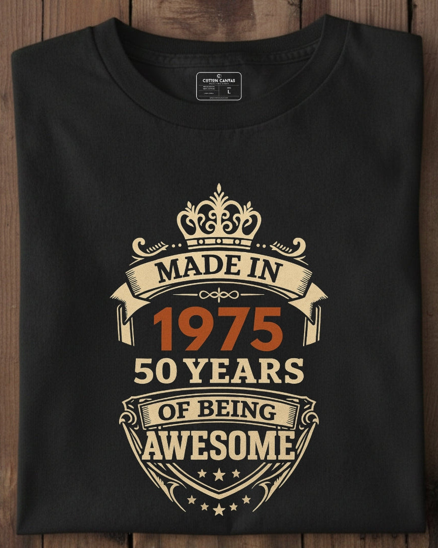 Black t-shirt with 'Made in 1975, 50 years of being awesome' design on a wooden surface