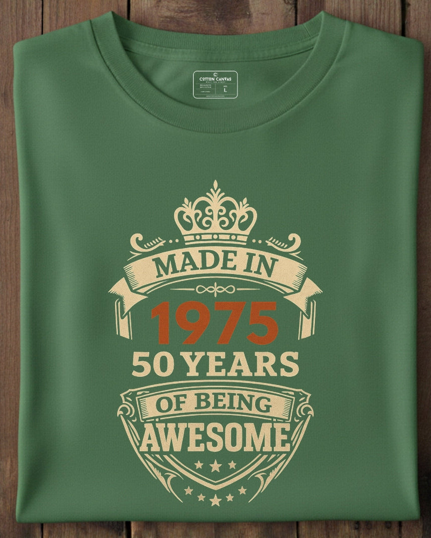 Green t-shirt with 'Made in 1975, 50 years of being awesome' text on a wooden surface