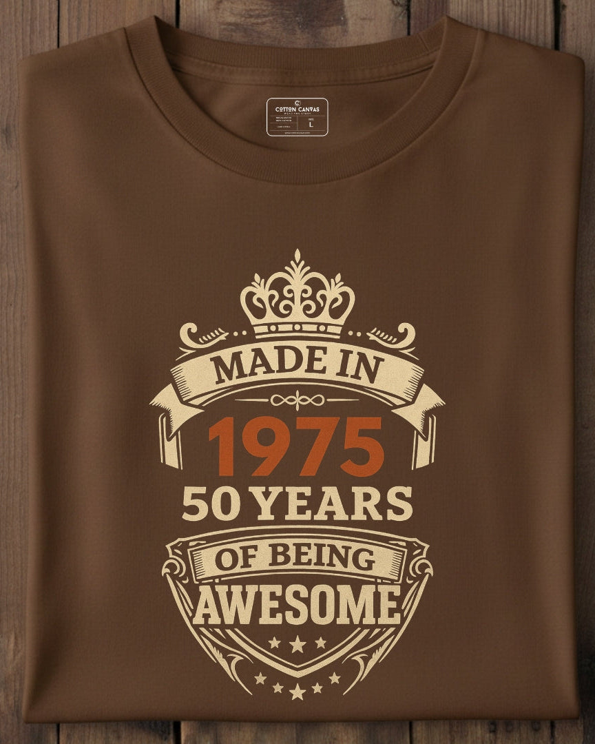 Brown t-shirt with 'Made in 1975, 50 years of being awesome' text on a wooden surface