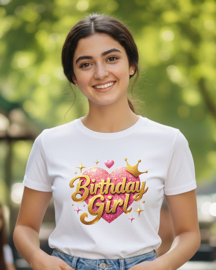 Woman wearing a 'Birthday Girl' t-shirt outdoors with greenery in the background