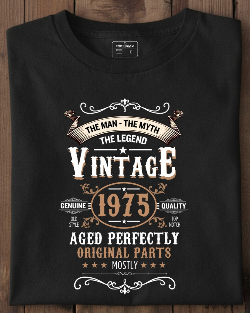 Black t-shirt with vintage-themed text design on a wooden surface