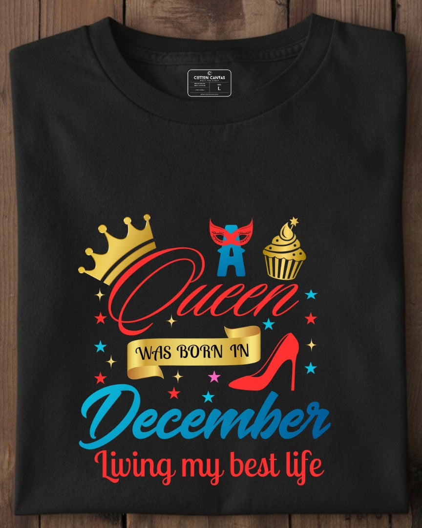 Black t-shirt with colorful graphics and text on a wooden surface