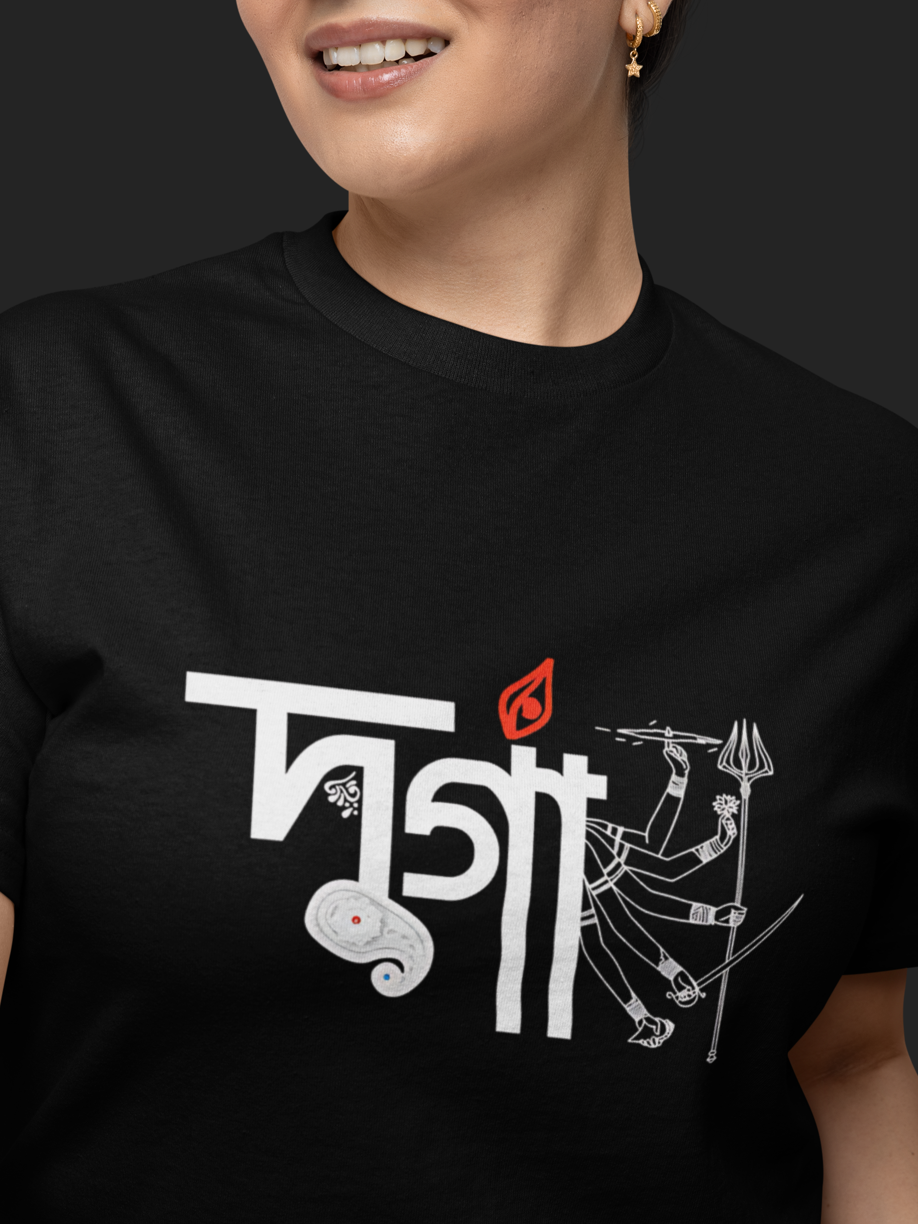 Person wearing a black t-shirt with white and red graphic design on a dark background