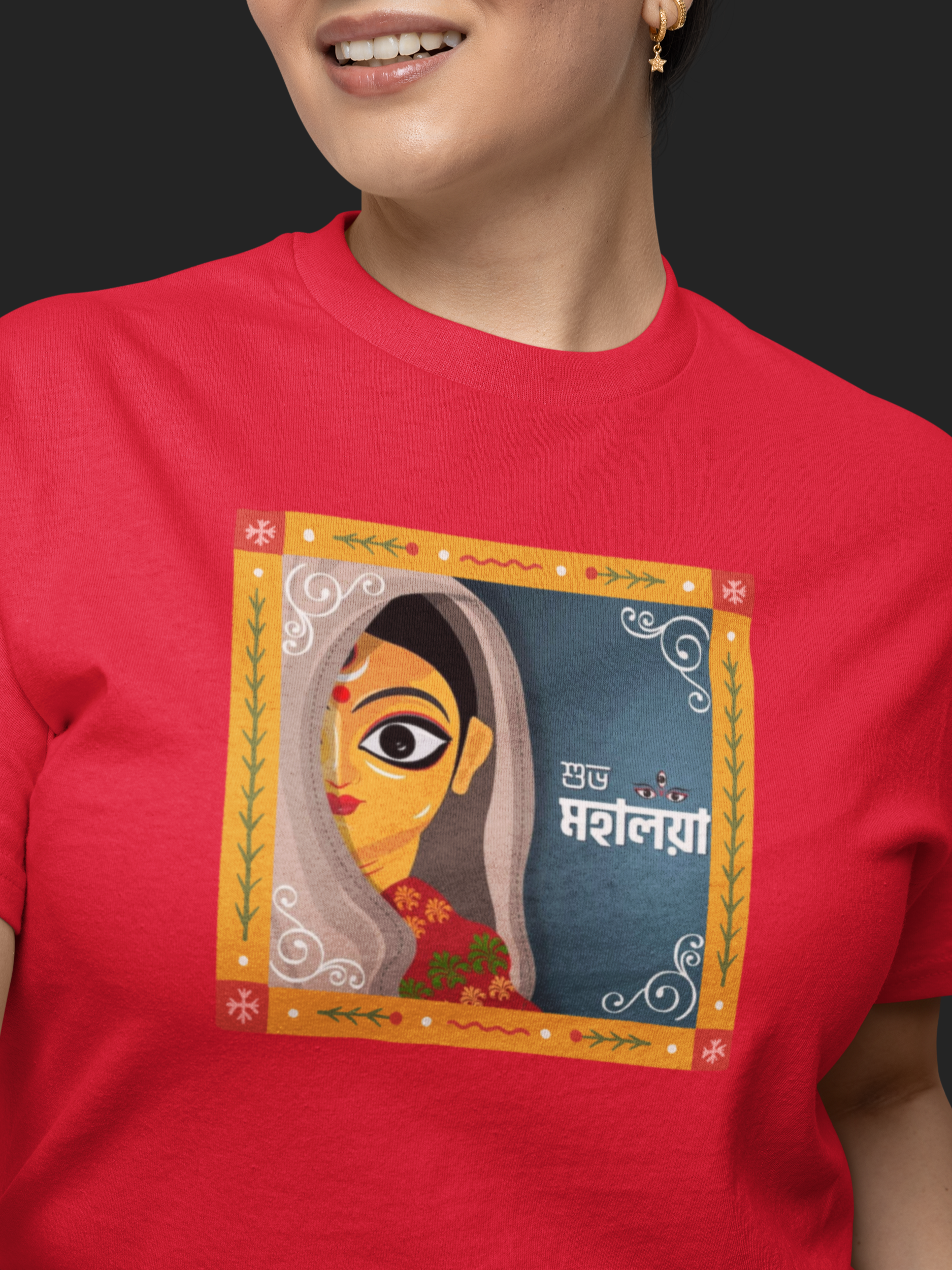 Person wearing a red t-shirt with a colorful graphic design on a black background