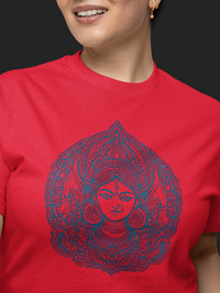 Person wearing a red t-shirt with a blue intricate design on a black background