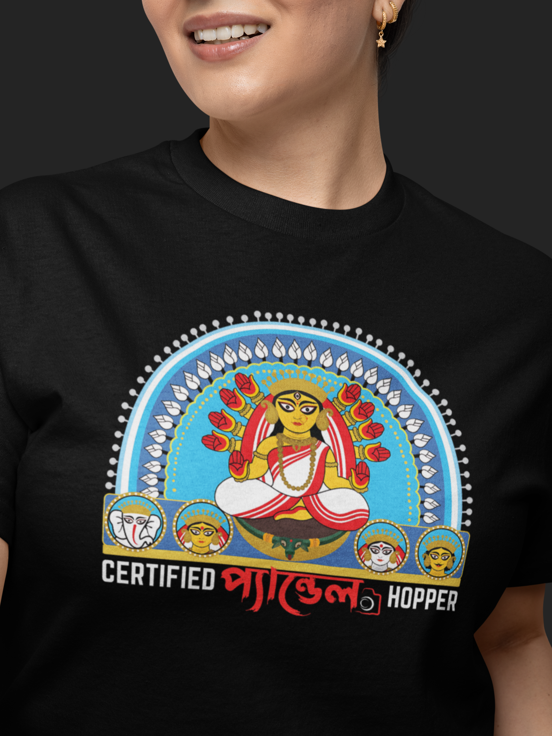 Person wearing a black t-shirt with a colorful graphic and text on a dark background