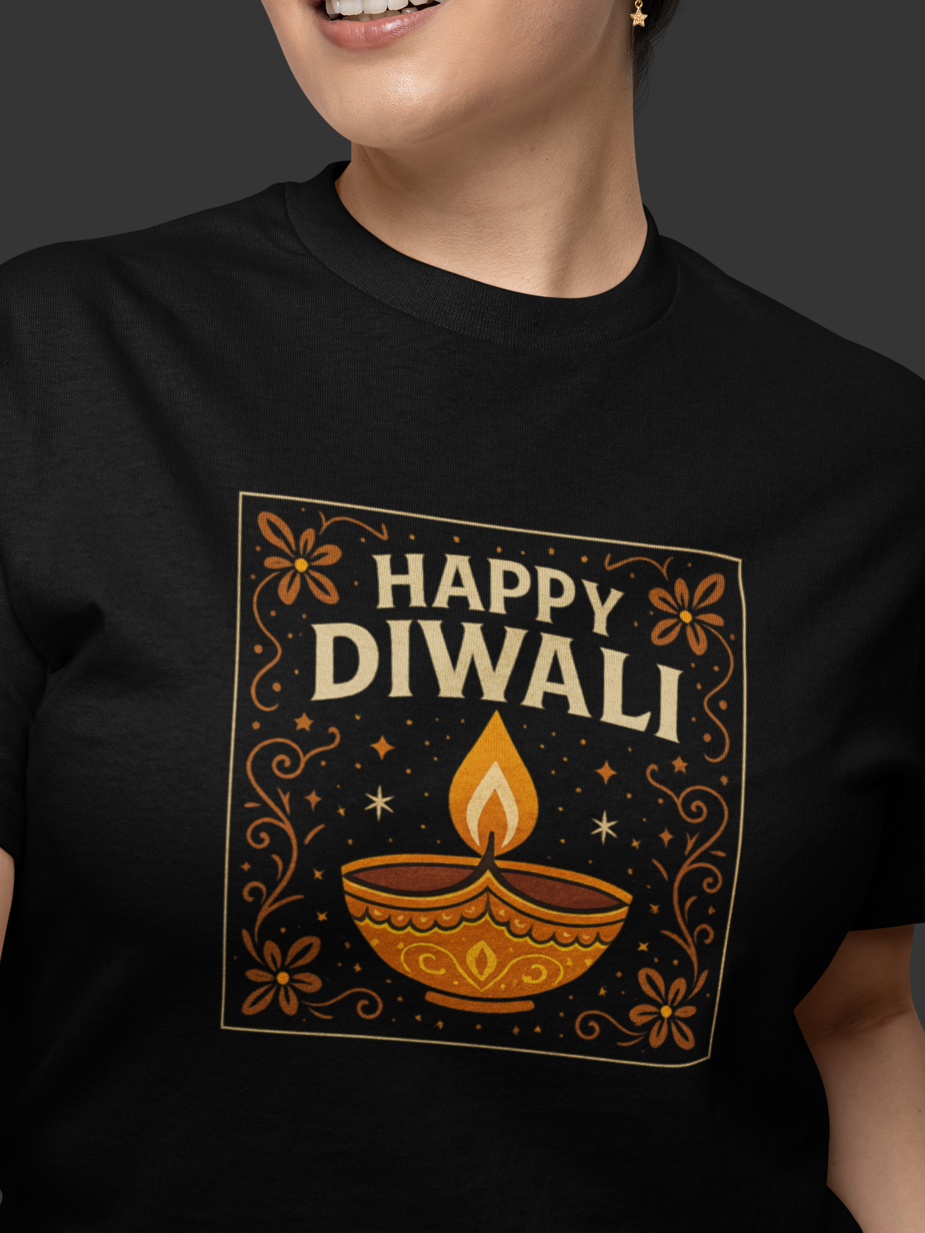 Person wearing a black t-shirt with 'Happy Diwali' design featuring a lamp and flowers.