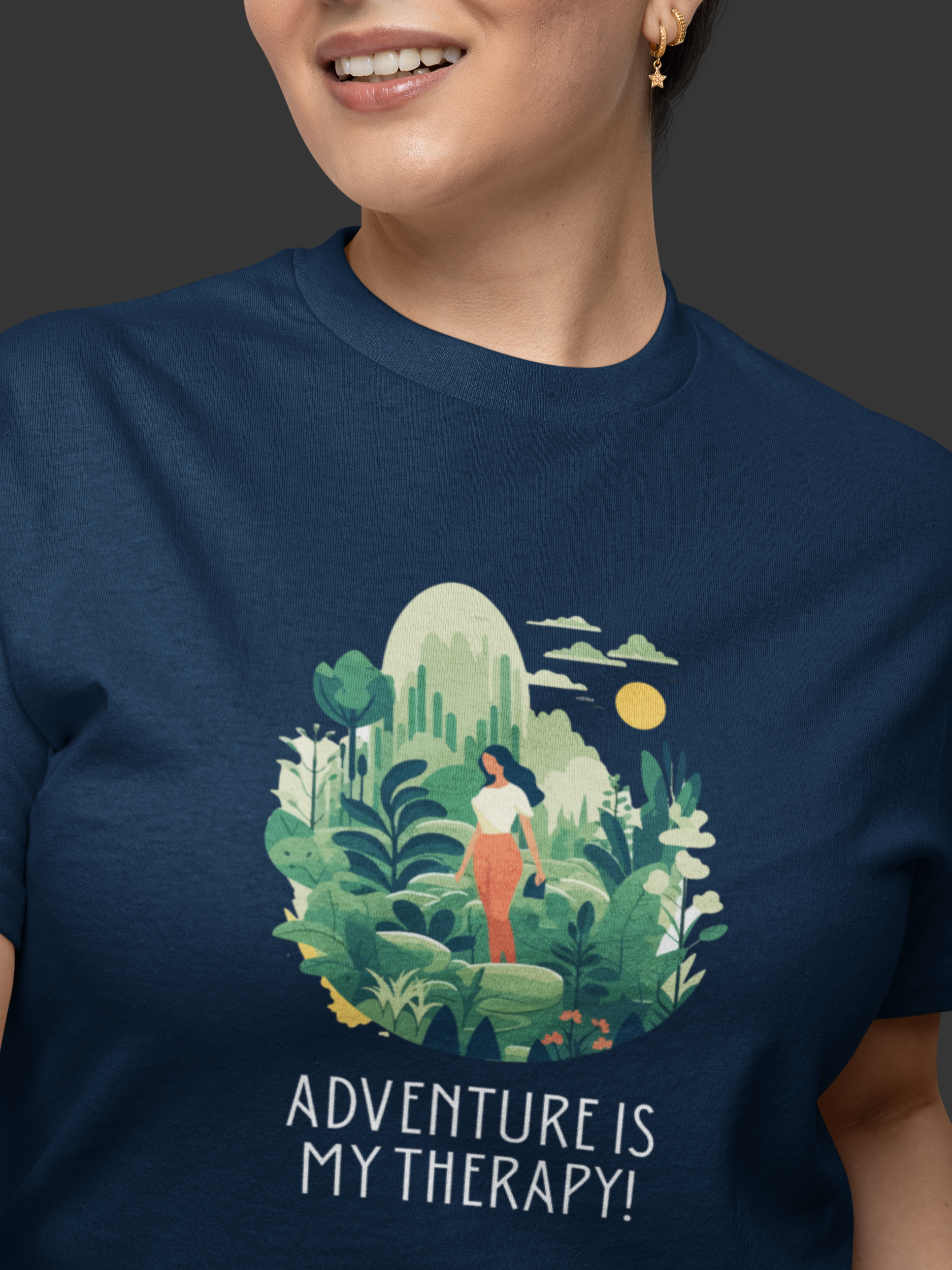 Person wearing a navy blue t-shirt with a nature-themed graphic and 'Adventure is My Therapy!' text.