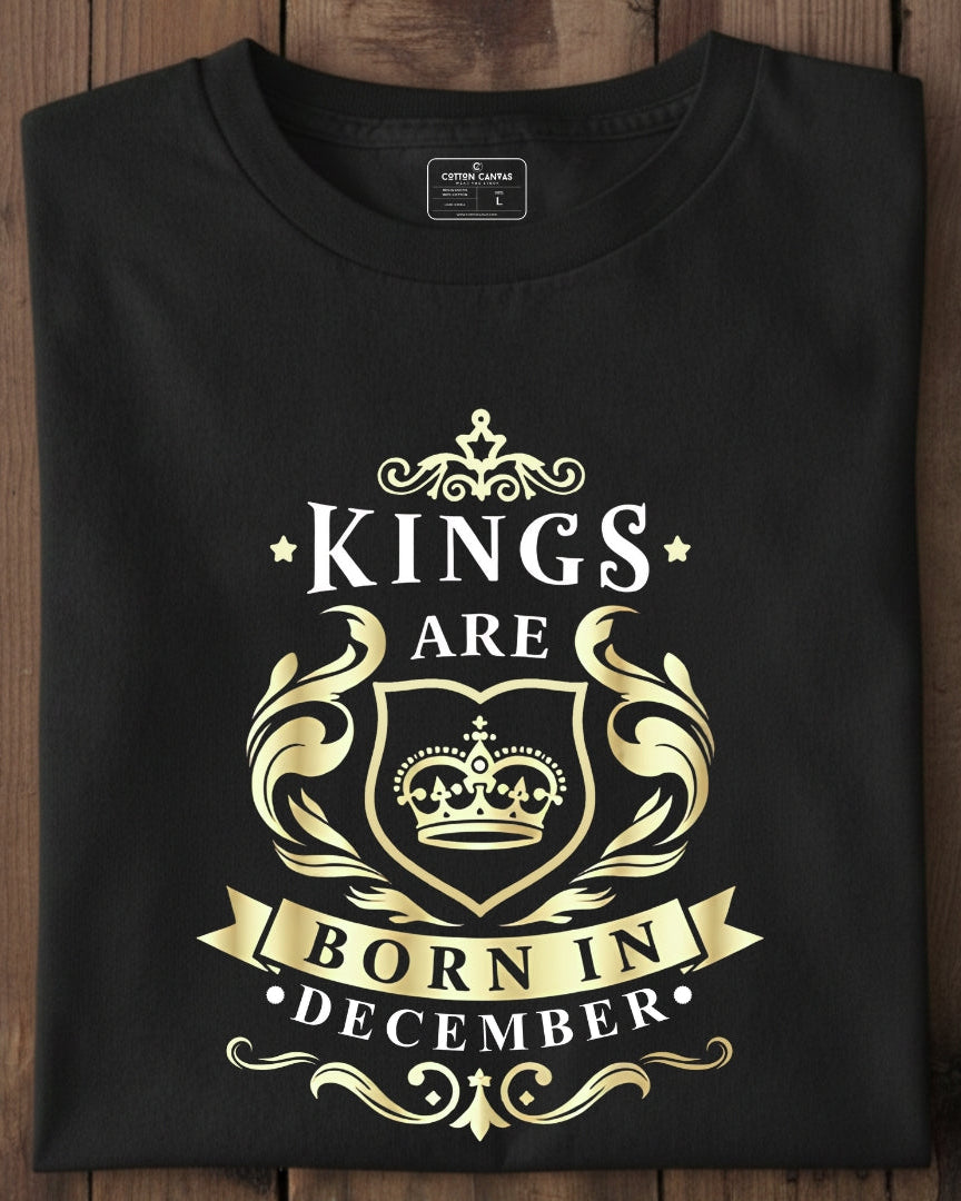 Black t-shirt with gold and white text and design on a wooden surface