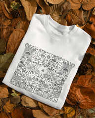 White sweatshirt with black geometric pattern on a bed of autumn leaves