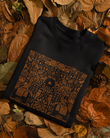 Black sleeveless sweater with a pattern on a bed of autumn leaves
