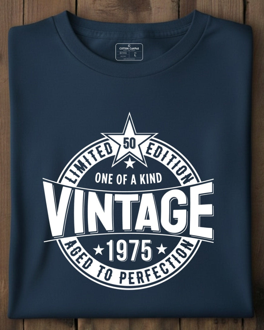 Folded navy blue t-shirt with white graphic design on a wooden surface