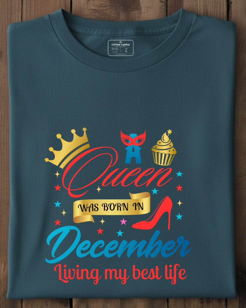 Folded blue t-shirt with colorful graphic and text on a wooden surface