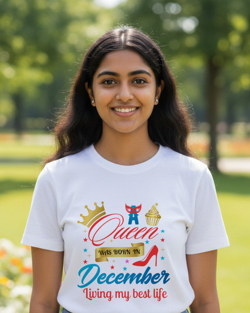 Person wearing a white t-shirt with a colorful graphic and text in a park.