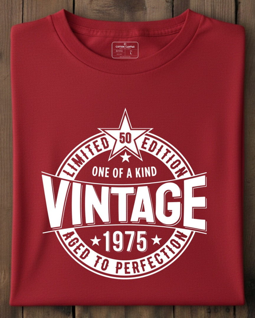 Folded red t-shirt with vintage design on a wooden surface