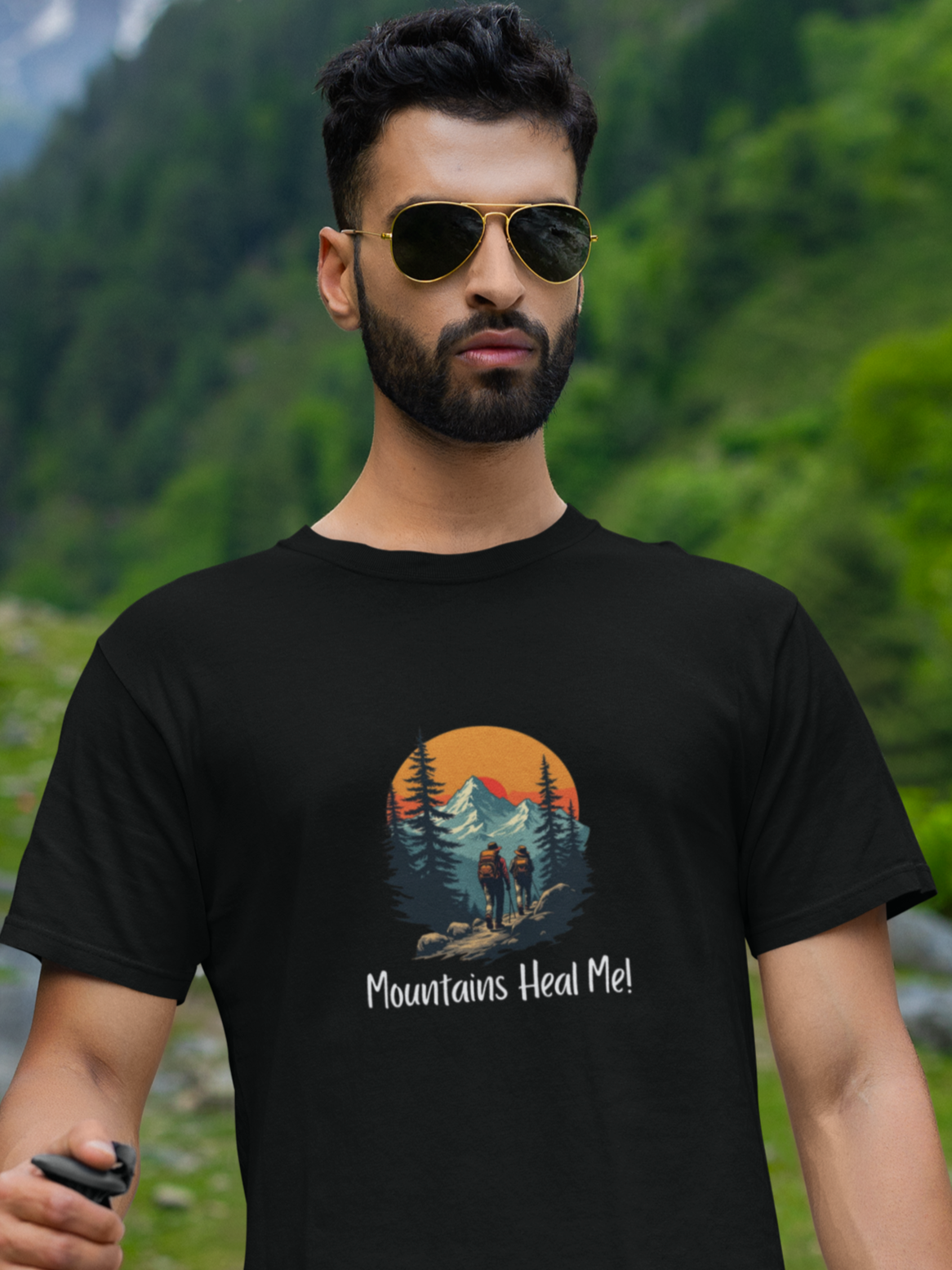 Man wearing a black t-shirt with 'Mountains Heal Me' design in a mountainous landscape